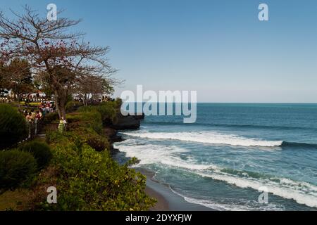 Touristen, die auf dem Tanah Lot Temple Trail am laufen Meer in Bali Stockfoto