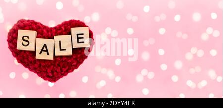 Banner Wort Verkauf auf roten Plüsch Herz verschwommen rosa Hintergrund mit Copy-Space mit schönen Bokeh von Girlanden Lichter. Konzept Urlaub schwarzen freitag, Stockfoto