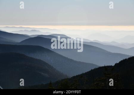 Spektakuläre Aussicht auf Bergketten Silhouetten und Nebel in Tälern während Sonnenuntergang in Stowe, Vermont, USA Stockfoto