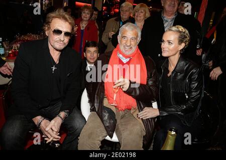 Johnny Hallyday, Laeticia Hallyday und Jean-Paul Belmondo bei der Grand Palais Funfair Party, die Marcel Campion am 19. Dezember 2013 in Paris veranstaltet hat. Foto von Jerome Domine/ABACAPRESS.COM Stockfoto