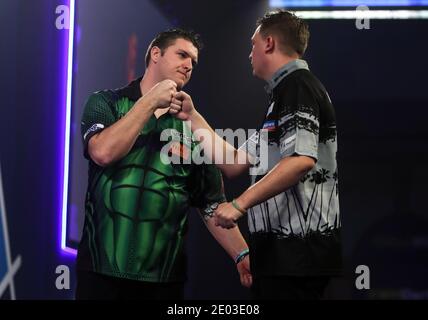 Daryl Gurney (links) stößt mit Chris Dobey nach dem Sieg am 12. Tag der William Hill World Darts Championship im Alexandra Palace, London, auf die Fäuste. Stockfoto