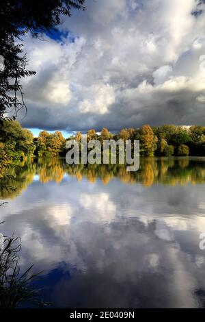 Herbst Farben über den See in Barnwell Country Park, Oundle, Northamptonshire, England, Großbritannien Stockfoto