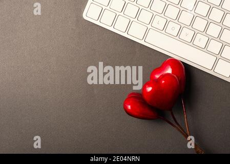 Selektive Fokus LIEBE Wort auf der Tastatur in der Nähe von roten Herzen, valentine Days Konzept mit Kopierraum. Stockfoto