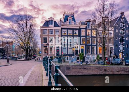 Amsterdam Niederlande bei Sonnenuntergang, historische Kanäle bei Sonnenuntergang. Holländische historische Kanäle in Amsterdam Stockfoto