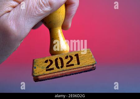 Deutschland. Dezember 2020. Ein alter Holzstempel mit Stempelflecken mit der Aufschrift '2021'. Foto mit Komposition vor neutralem Hintergrund. Quelle: dpa/Alamy Live News Stockfoto