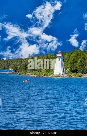 Helle Nachmittagswolken über dem Leuchtturm am Lake Huron. Spektakuläre Landschaft im Sommer in Georgian Bay in ON, Kanada. Es gibt über 30,000 isla Stockfoto