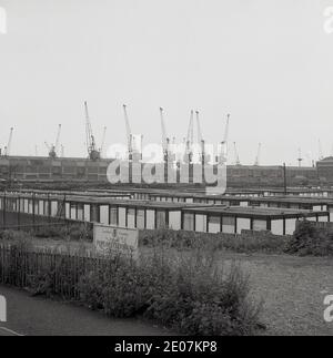 Ende der 1950er Jahre, ein historisches Bild, das einige der temporären einstöckigen Fertighütten des Poplar Technical College in East London, England, zeigt, früher bekannt als School of Engineering and Navigation. Der berühmte Regisseur Alfred Hitchcock, geboren im nahegelegenen Leytonstone, besuchte die maritime Schule, deren Hauptgebäude in der Poplar High St während des Zweiten Weltkriegs beschädigt worden war, ebenso wie das gesamte East End von London, das während des Blitz schwer bombardiert worden war. Kraniche sind in der Ferne neben der Themse zu sehen. Stockfoto