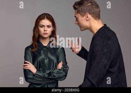 Ein empörter Mann in einer schwarzen Jacke stiert mit seinem Hände und sieht die Frau an Stockfoto