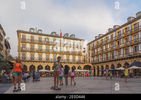 San Sebastian, Spanien - August 29 2015: Ein paar junge Skateboarderinnen fahren durch die Plaza Constitucion im Herzen der Altstadt von San Sebastian Stockfoto