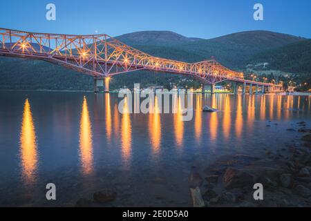 Die ikonische Big Orange Bridge in Nelson, B.C. an einem Sommerabend nach Sonnenuntergang. Stockfoto