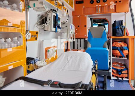 Interieur von zeitgenössischen Ambulanzwagen mit verschiedenen professionellen Instrumenten ausgestattet Und medizinische Trage Stockfoto