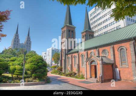 Jeil Kirche hinter der Kathedrale unserer Dame von Lourdes in Daegu, Republik Korea gesehen Stockfoto