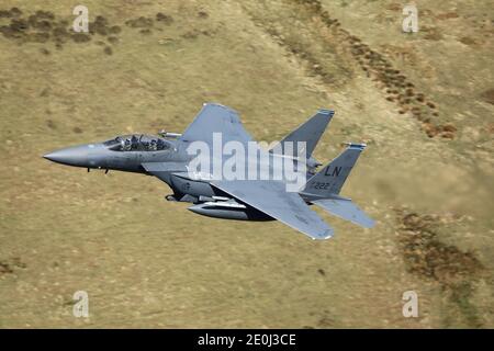 USAF F-15E Schlagen Sie Eagle auf einem Low-Level-Flug in der 'Mach Loop'-Region von Wales, Großbritannien. Stockfoto