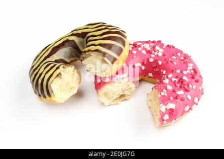 Zwei gebissene Donuts mit buntem Glasur isoliert auf weißem Hintergrund.Delicious Schokoladen-Donuts Stockfoto