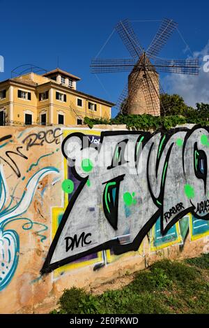 Moderne Graffiti kontrastiert lebhaft mit einer traditionellen Windmühle im Viertel Es Jonquet von Palma City, Balearen, Spanien, Europa. Stockfoto