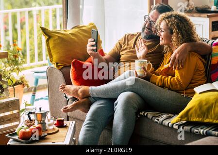 Erwachsene glückliches Paar Mann und Frau zu Hause genießen Morgen Frühstück und Videoanruf an Freunde oder Eltern - Fröhliche kaukasische Menschen Indoor-Acti Stockfoto