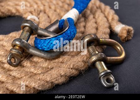 Schäkel und Seil auf dem Tisch. Zubehör für Seewölfe auf dem Tisch. Dunkler Hintergrund. Stockfoto