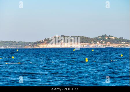 Blaues Wasser des Golfs von Saint-Tropez mit Umrissen der Stadt Saint-Tropez im Hintergrund, Französische Riviera, Frankreich im Sommer Stockfoto