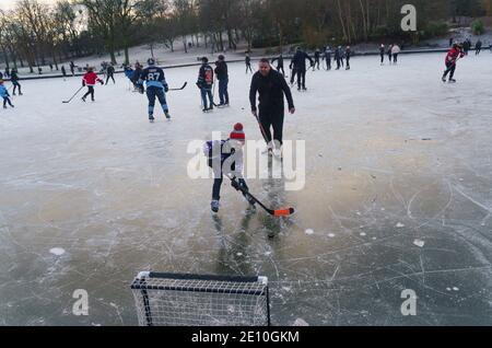 Glasgow, Schottland, Großbritannien. Januar 2021. Begeisterte Amateur-Eishockeyspieler und ein paar Eiskunstläufer nutzten heute Morgen die eisigen Temperaturen und einen seltenen gefrorenen Teich im Queens Park in Glasgow. Iain Masterton/Alamy Live News Stockfoto