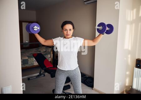 Weibliche Bodybuilder arbeiten mit Handgewichten Stockfoto