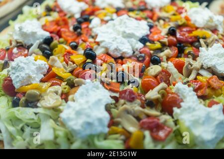 Pizza aus der Nähe, frische Pizza mit Tomaten, Käse und Pilzen auf Holztisch Stockfoto