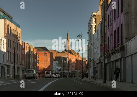 Thomas Straße mit John's Lane Kirche (Kirche St. Augustine und St. John) im Hintergrund. Dublin, Irland. Stockfoto