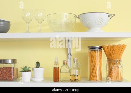 Set von Utensilien und Gläsern mit Produkten in der Küche Regale Stockfoto