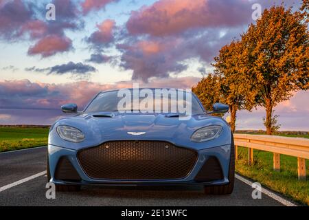 Aston Martin DBS superleggera auf einer malerischen Straße bei Sonnenuntergang Stockfoto