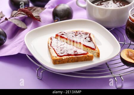 Brotscheiben mit köstlicher hausgemachter Pflaumenmarmelade auf dem Teller Stockfoto