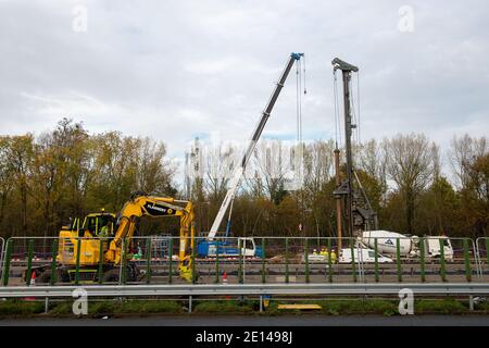 Langley, Slough, Berkshire, Großbritannien. November 2020. Die Modernisierung der M4 Smart Motorway wird in der Nähe der Anschlussstelle M4 nach Langley, Slough in Berkshire fortgesetzt. Derzeit gibt es Geschwindigkeitsbeschränkungen für die M4 von 50 mph, während die M4 zu einer digitalen Autobahn mit variablen Geschwindigkeitsbegrenzungen aufgerüstet wird. In Großbritannien wurden in den letzten fünf Jahren 35 Menschen auf Smart Motorways getötet, und viele Bewohner von Berkshire werden die M4 nicht mehr benutzen, sobald die Smart Motorway aus Sicherheitsgründen in Betrieb genommen wird, da die harte Schulter entfernt und durch zeitweise auftretende Notfallbereiche ersetzt wird. Die alte footbri Stockfoto