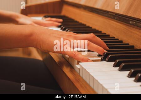 Pianist spielt Klavier, Nahaufnahme von Händen und Tasten, Seitenansicht Stockfoto