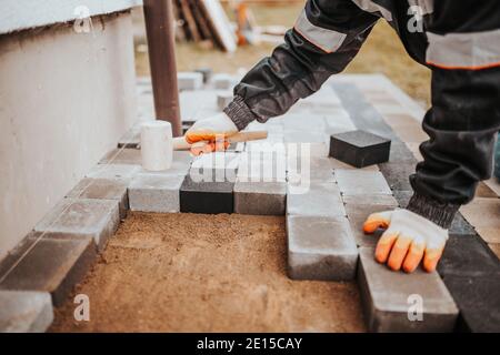 Werkzeuge zum Verlegen und Installieren von Pflasterplatten - Schnur Kelle Und Gummihammer Stockfoto