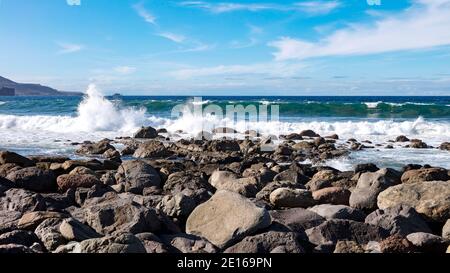 Wellen brechen auf den Steinen von Playa de las Canteras, Las Palmas de Gran Canaria, Spanien Stockfoto