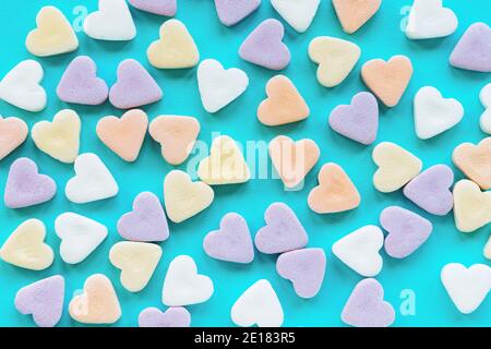 Bunte Zuckerrüben in Herzform auf blauem Hintergrund. Kreatives Urlaubskonzept der Liebe. Valentinstag. Stockfoto