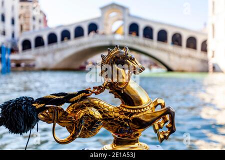 Ein goldenes Pferd Dekoration auf EINER Gondel mit der Rialtobrücke im Hintergrund, Venedig, Italien. Stockfoto