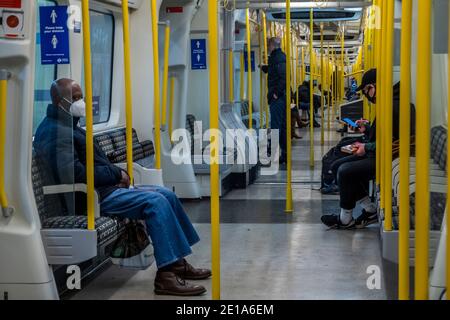 London, Großbritannien. Januar 2021. Die U-Bahn ist immer noch ziemlich voll trotz der neuen nationalen Lockdown, Stay at Home, Anweisungen. Die meisten Reisenden tragen Maskenabdeckungen, die bereits obligatorisch sind. Kredit: Guy Bell/Alamy Live Nachrichten Stockfoto