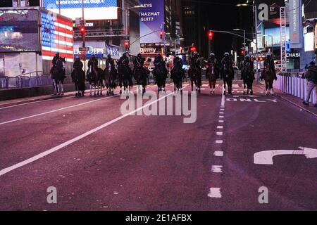 Die NYPD hat während der Silvesternacht auf einem meist leeren Times Square in New York City Polizeistreifenstraßen aufgestellt.durchschnittlich zieht es etwa eine Million Nachtschwärmer an die Kreuzung der Welt, um Aufführungen zu sehen und das neue Jahr zu feiern. In diesem Jahr durfte ein begrenztes Live-Publikum von etwa 40 Ersthelfern und wichtigen Arbeitern den Neujahrsball aus einem sicheren Bereich am Times Square fallen sehen. Stockfoto