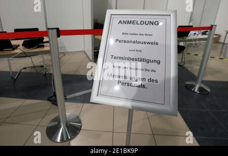 Laage, Deutschland. Januar 2021. An der Einfahrt zum Impfzentrum des Rostocker Bezirks im Terminal des Flughafens Rostock-Laage weist ein Schild "Anmeldung" den Weg, die einzelnen Arbeitsplätze sind mit roten Schrankbändern gesichert. Am 12.01.2021 sollen die Impfzentren des Staates ihre Arbeit beginnen. Quelle: Bernd Wüstneck/dpa-Zentralbild/dpa/Alamy Live News Stockfoto