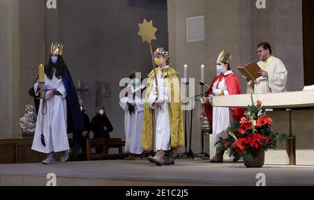 Magdeburg, Deutschland. Januar 2021. Junge Leute, die als Liedgesänger gekleidet sind, gehen während eines Gottesdienstes in der römisch-katholischen Kathedrale von St. Sebastian. Die Gläubigen feierten am Mittwoch in Magdeburg den Dreikönigsgottesdienst. Der "Epiphanie"-Feiertag am 6. Januar ist einer der wichtigsten Festtage für Katholiken. Der Gottesdienst in der St. Sebastian Kirche wurde auch in diesem Jahr live im Internet übertragen. Quelle: Ronny Hartmann/dpa-Zentralbild/dpa/Alamy Live News Stockfoto