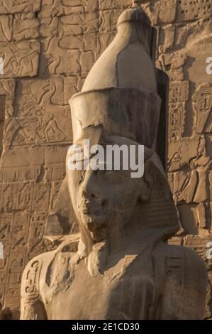 Luxor. Dies ist eine von mehreren Statuen des Pharao König Ramesses II am Eingang zum 3500 Jahre alten UNESCO-Weltkulturerbe des Tempels von Luxor, Teil des größten Tempelkomplexes der Welt, Das Hotel liegt auf dem Nil an der Stadt Luxor früher in der alten Welt als Theben bekannt, deren Bau ist weitgehend gutgeschrieben Ramesses II, Ramesses der große. Stockfoto