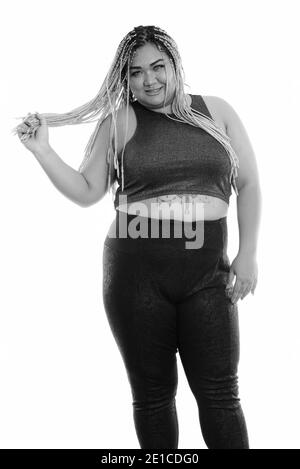 Studio shot der Jungen gerne Fett asiatische Frau lächelnd beim Stehen und spielen mit Ihrem Haar Stockfoto