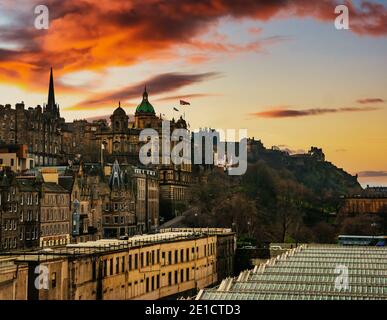 Blick über das Glasdach des Waverley Bahnhofs auf den Mound & Edinburgh Castle bei Sonnenuntergang, Edinburgh, Schottland, Großbritannien Stockfoto