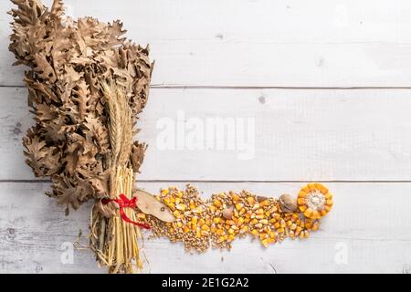 Draufsicht auf Eichenzweige mit Weizen- und Maiskörnern Und die Nüsse auf dem hölzernen Tisch mit der Kopiefläche - orthodox weihnachten badnjak Konzept Stockfoto