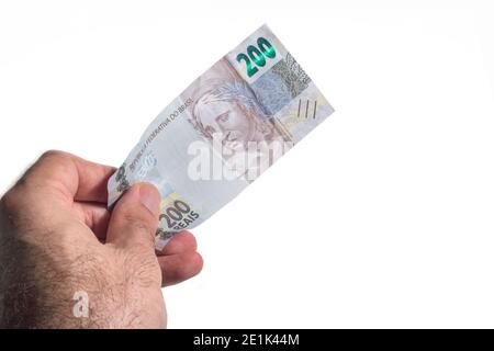 Hand hält ein brasilianisches Geld zweihundert echte Rechnung Stockfoto