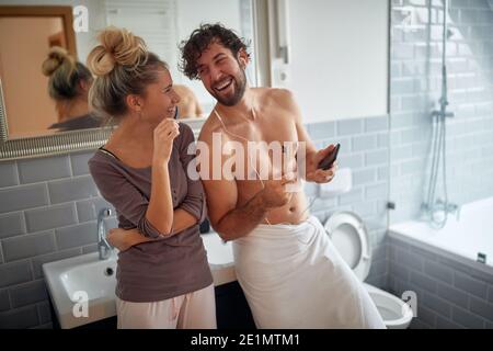 Fröhliches Paar Zähneputzen zusammen am Morgen Stockfoto