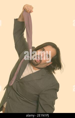 Fat kaukasischen Geschäftsmann seine eigene Riegel ziehen Stockfoto