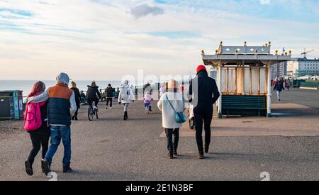 Brighton UK 8. Januar 2021 - Menschen gehen an der Küste von Hove entlang, während die COVID-19-Sperrbeschränkungen in England weiterlaufen : Credit Simon Dack / Alamy Live News Stockfoto