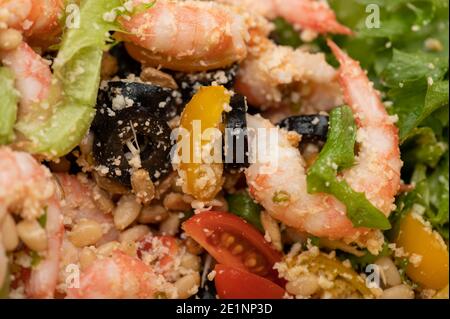 Gemüsesalat mit Garnelen und Pinienkernen auf einem Teller. Hausgemachtes Essen. Nahaufnahme Stockfoto