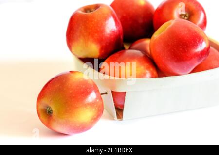 Frische rote Äpfel im Korb auf weißem Hintergrund. Gesunde vegetarische Ernährung Konzept. Stockfoto