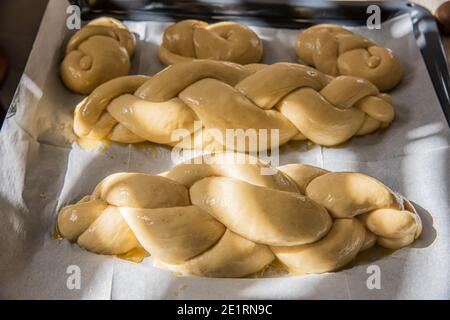 Hausgemachtes Challah-Brot backen. Vor dem Backen in einer Pfanne mit Sesamsamen umflechten. Der Teig puffte vor dem Backen. Hochwertige Fotos Stockfoto